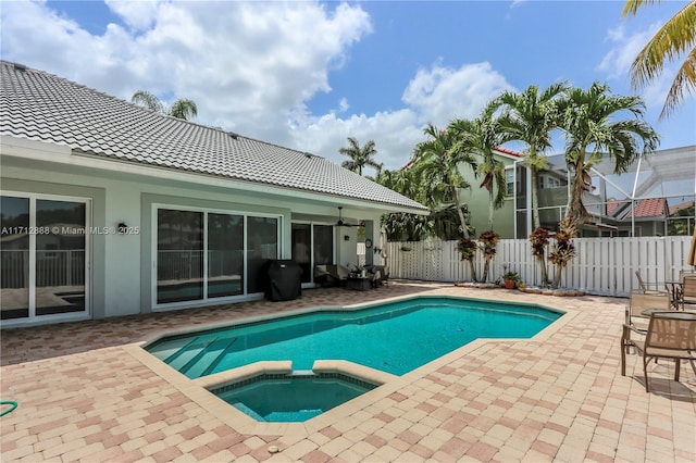 view of pool featuring an in ground hot tub, ceiling fan, and a patio