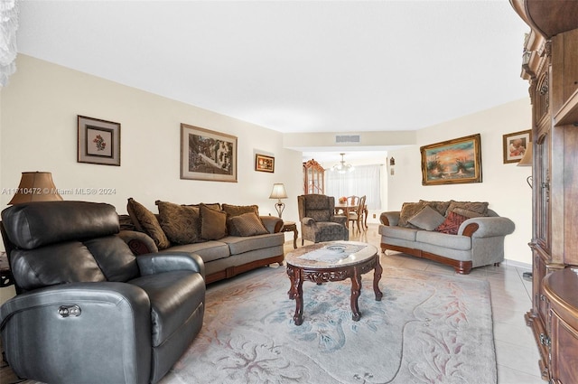 living room featuring light tile patterned floors and an inviting chandelier