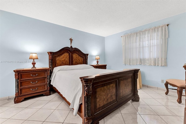 tiled bedroom featuring a textured ceiling