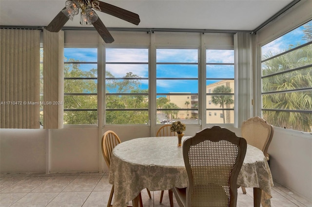 tiled dining space with ceiling fan