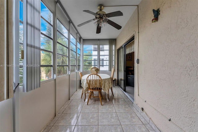 sunroom featuring ceiling fan and a healthy amount of sunlight