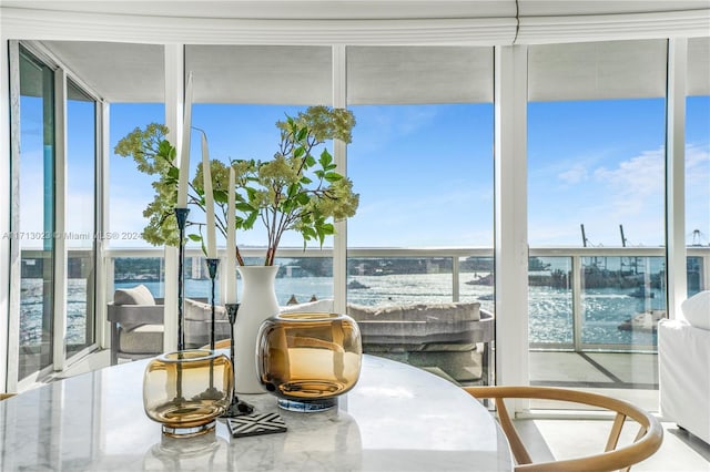 sunroom / solarium featuring a water view