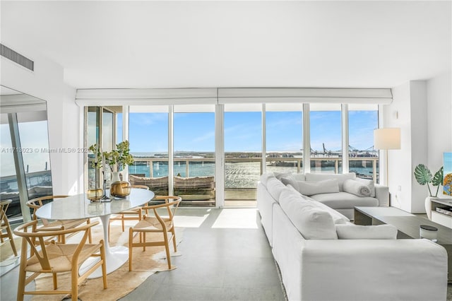 living room with concrete floors and a water view