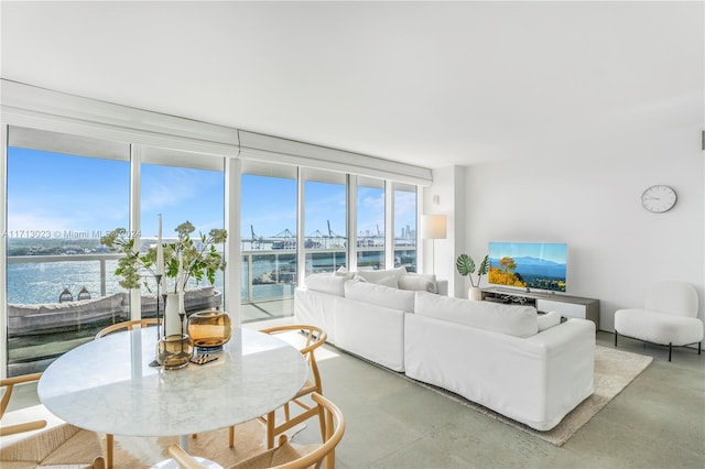 living room featuring expansive windows and a water view