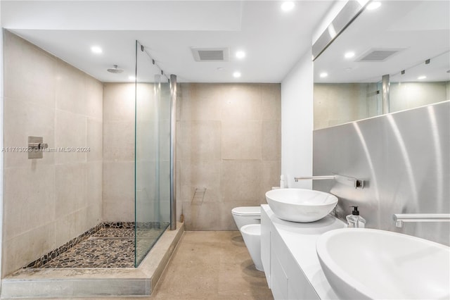 bathroom featuring a tile shower, a bidet, tile walls, and toilet