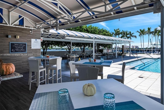 view of patio / terrace featuring an outdoor bar and a community pool