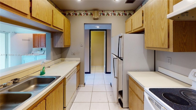 kitchen with washer and clothes dryer, white appliances, sink, light tile patterned floors, and extractor fan