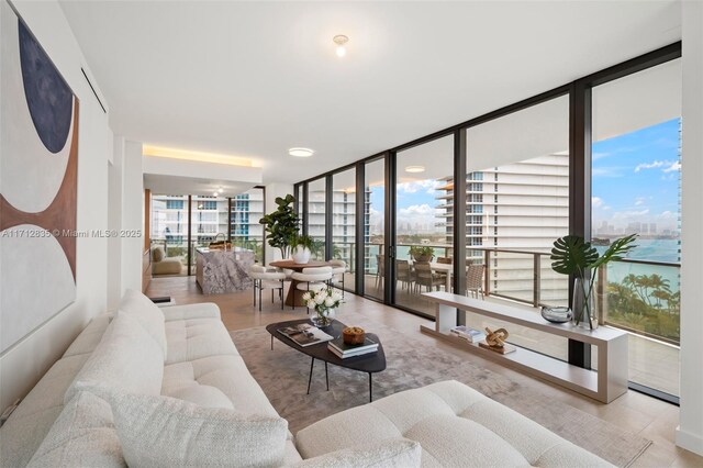 living room featuring light hardwood / wood-style flooring and a wall of windows