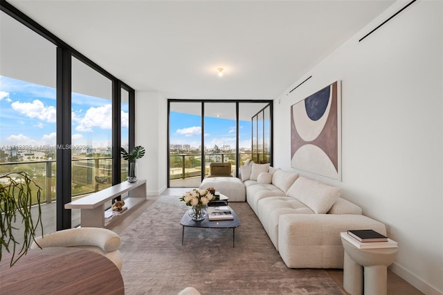 living room featuring baseboards and floor to ceiling windows