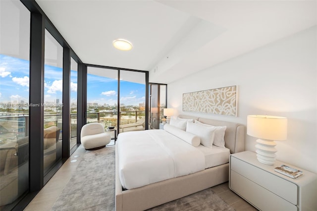 bedroom featuring expansive windows and a city view