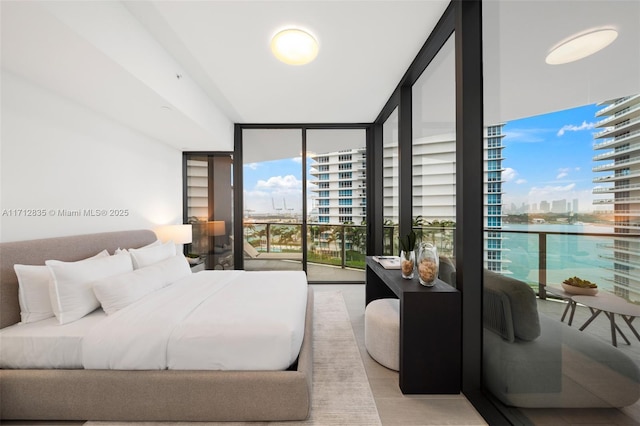 bedroom featuring access to outside and expansive windows