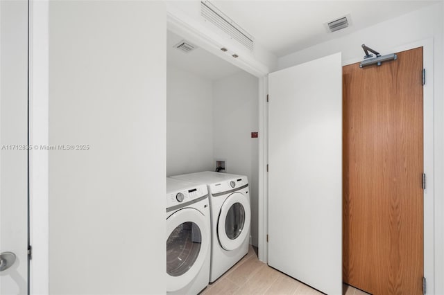 laundry room featuring laundry area, washer and clothes dryer, and visible vents