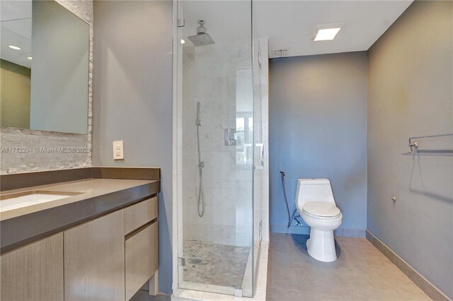 bathroom featuring toilet, vanity, and walk in shower