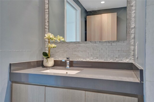 bathroom with decorative backsplash and vanity