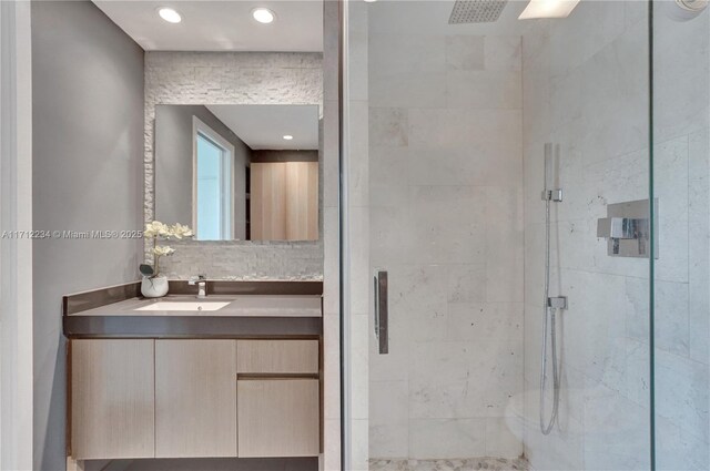 bathroom featuring vanity and a shower with shower door