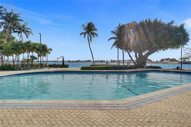 view of swimming pool with a water view