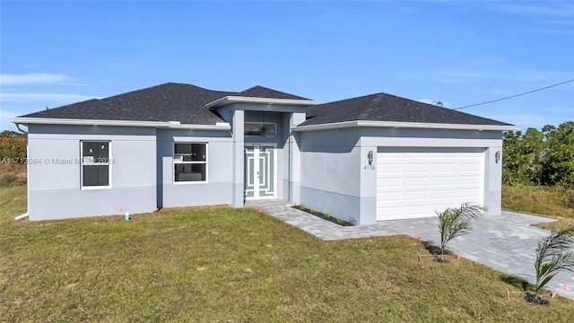 prairie-style home with a garage and a front lawn