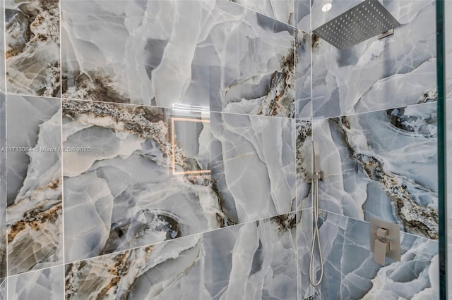 interior details with a tile shower