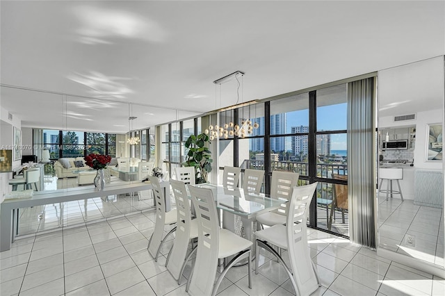 tiled dining space with plenty of natural light, floor to ceiling windows, and a chandelier