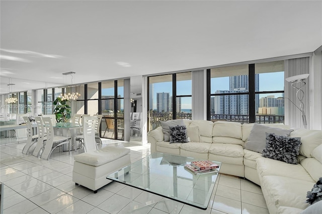 tiled living room featuring expansive windows, a healthy amount of sunlight, and a chandelier