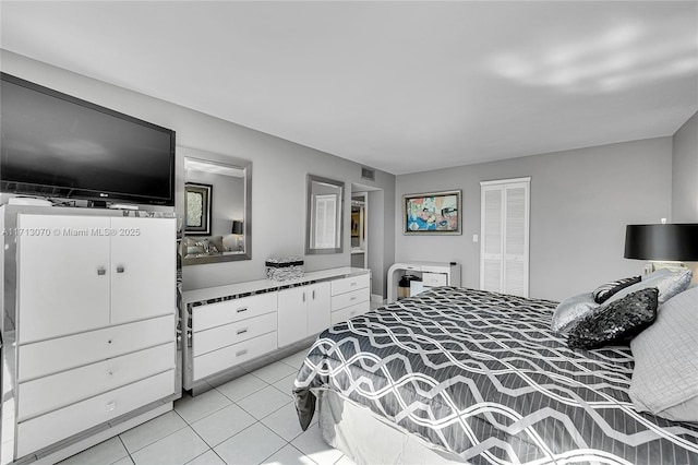 tiled bedroom with a closet