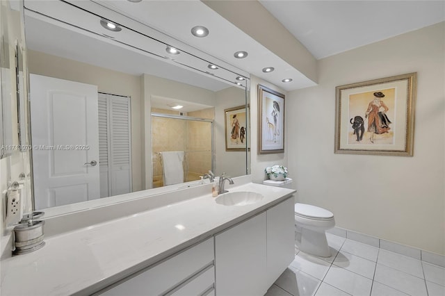 bathroom with vanity, a shower with door, tile patterned floors, and toilet