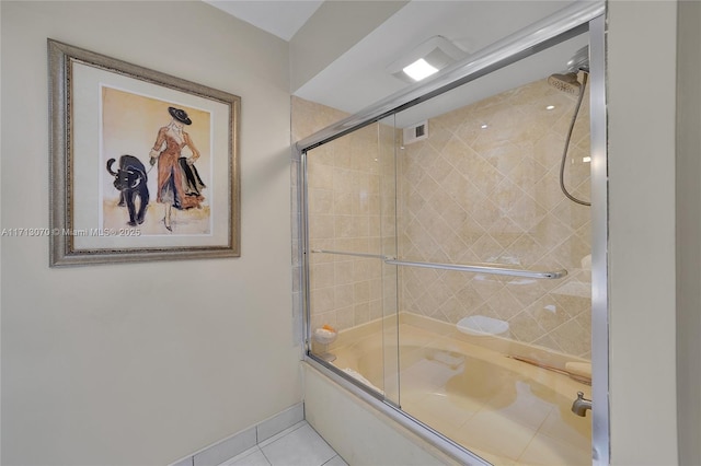 bathroom featuring tile patterned floors and shower / bath combination with glass door