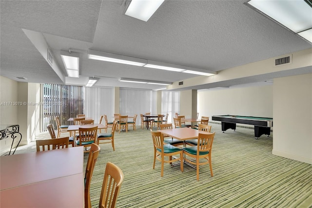 dining area with a textured ceiling and carpet