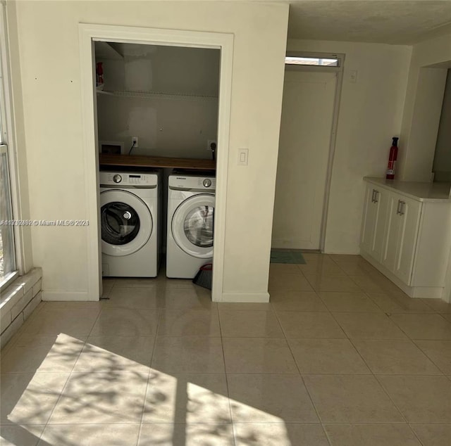 laundry room featuring light tile patterned flooring and separate washer and dryer