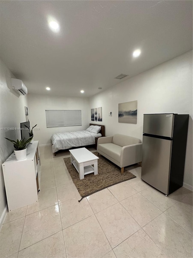 bedroom featuring a wall unit AC, recessed lighting, light tile patterned floors, visible vents, and freestanding refrigerator