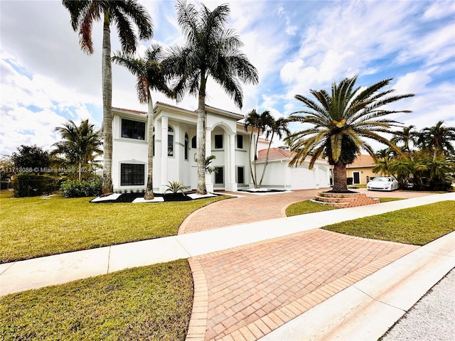 view of front of property featuring a garage and a front lawn