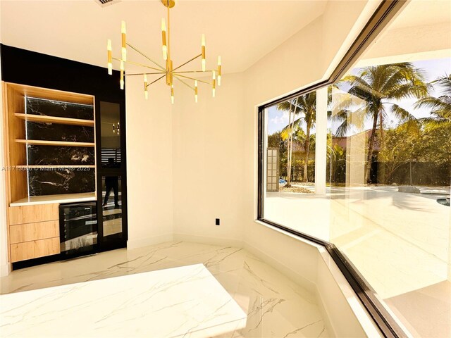 interior space featuring a high ceiling, french doors, and a notable chandelier