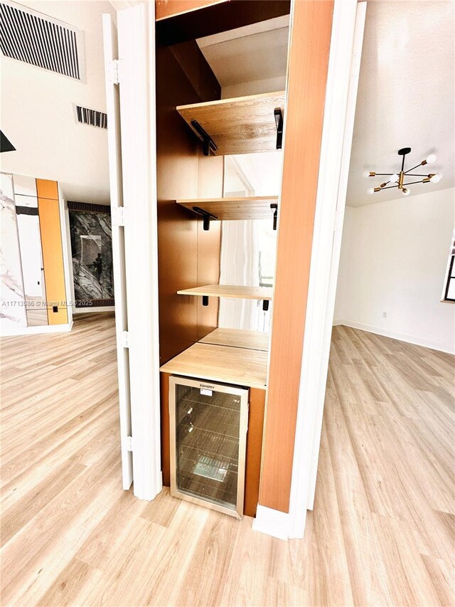 bathroom with vanity, toilet, an enclosed shower, and wooden walls