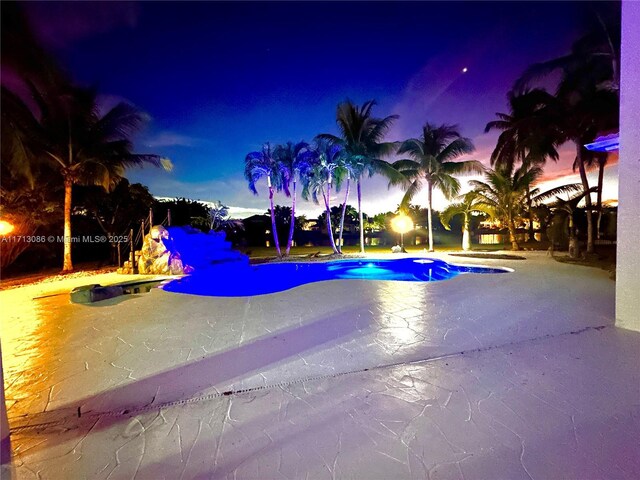 view of swimming pool with a water view and a yard