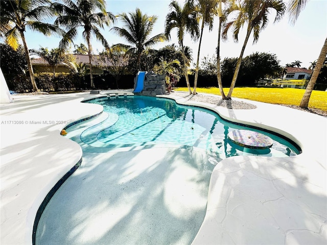 view of pool featuring a yard and a water slide