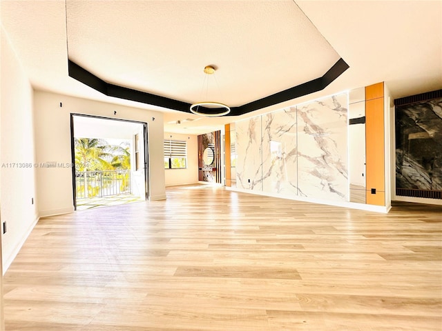 interior space featuring a textured ceiling and light hardwood / wood-style flooring