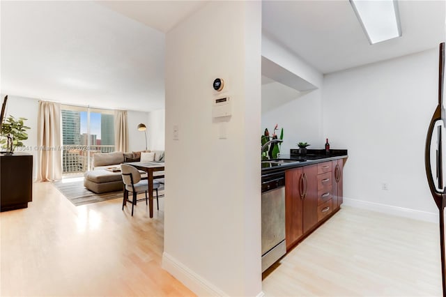 kitchen featuring sink, dishwasher, white fridge, and light hardwood / wood-style flooring