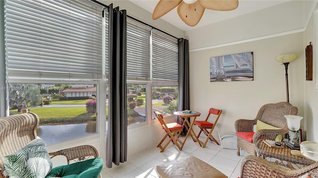 living area featuring ceiling fan and light tile patterned flooring