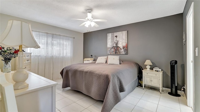 tiled bedroom with ceiling fan and a textured ceiling