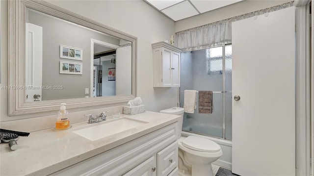 full bathroom with shower / bath combination with glass door, vanity, and toilet