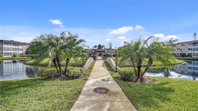 view of property's community featuring a yard and a water view