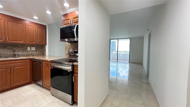 kitchen with backsplash, sink, light tile patterned floors, and stainless steel appliances