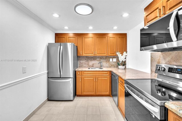 kitchen featuring sink, light tile patterned floors, appliances with stainless steel finishes, ornamental molding, and light stone countertops