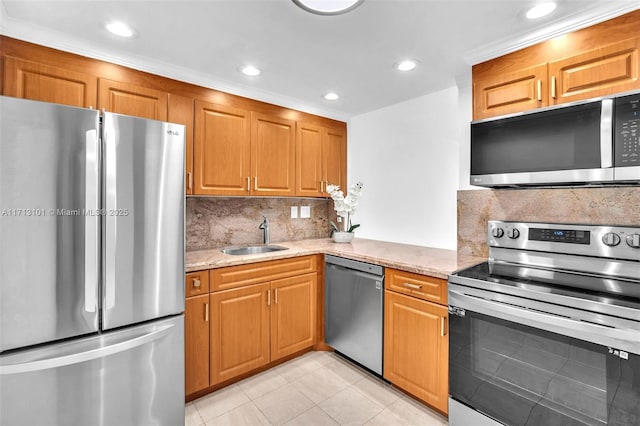 kitchen with light stone counters, sink, light tile patterned floors, and stainless steel appliances