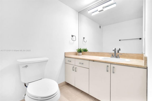 bathroom with vanity, tile patterned floors, and toilet