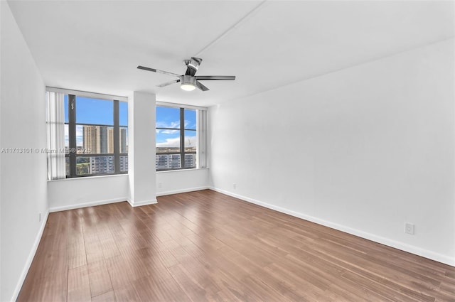 spare room featuring ceiling fan and hardwood / wood-style floors