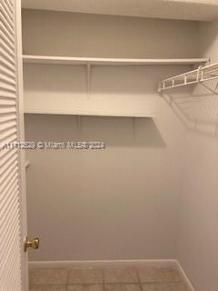 walk in closet featuring tile patterned flooring