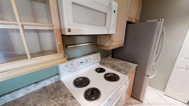 kitchen with light tile patterned floors and white appliances