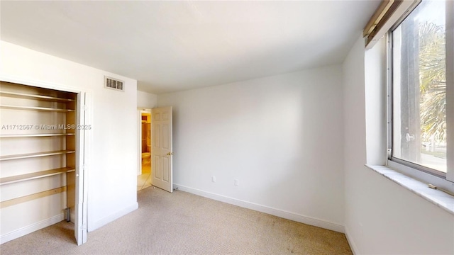 unfurnished bedroom with light colored carpet