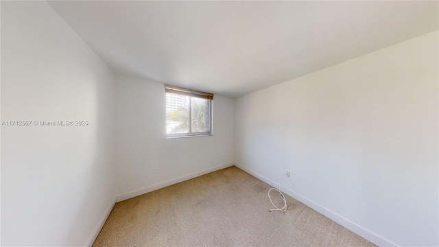 unfurnished room with light carpet